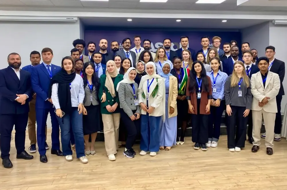 Group portrait of delegates in a modern hall